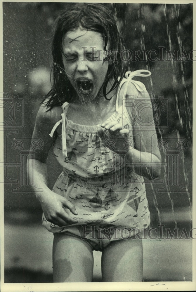1983, Shelly Chaudoir, Sturgeon Bay, runs through water sprinkler - Historic Images