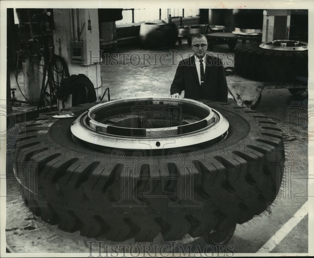 1965, Cliff Chatterson with tire produced at Eau Claire plant - Historic Images