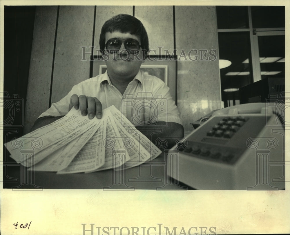 1985, John Swedowski holds phone bills, Milwaukee - mjc13079 - Historic Images