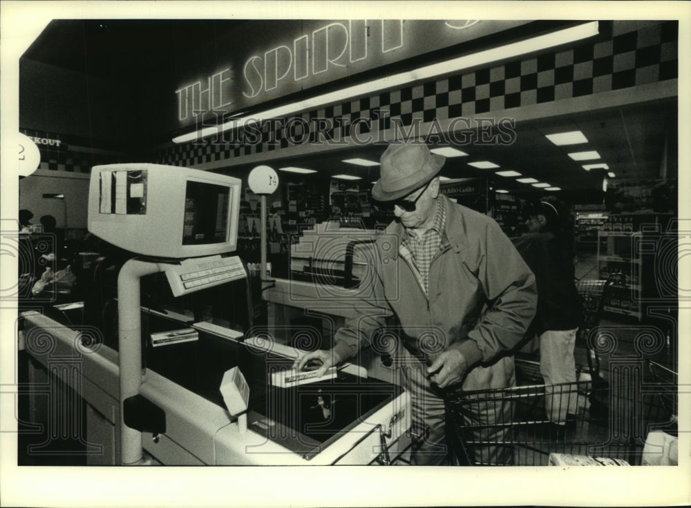 1992 H.F. Kutsch uses CheckRobot to ring up groceries in Brookfield - Historic Images