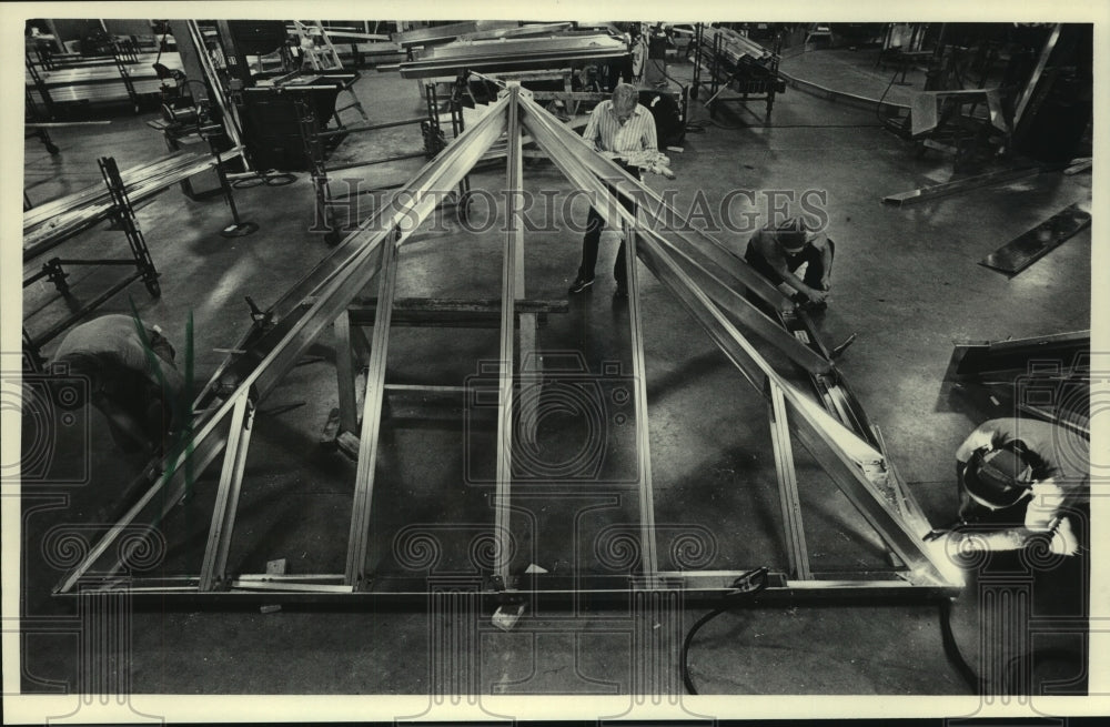 1985, Workers at Super Sky International Inc. assemble skylight - Historic Images
