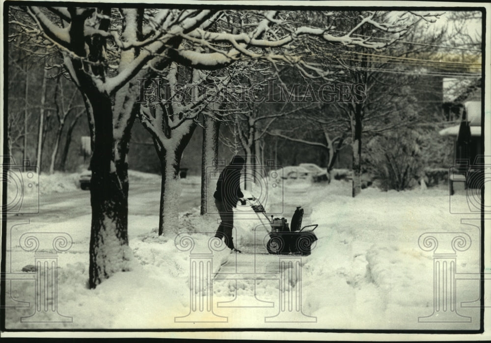 1993, John Cartwright flows snow from in front of his Wisconsin home - Historic Images