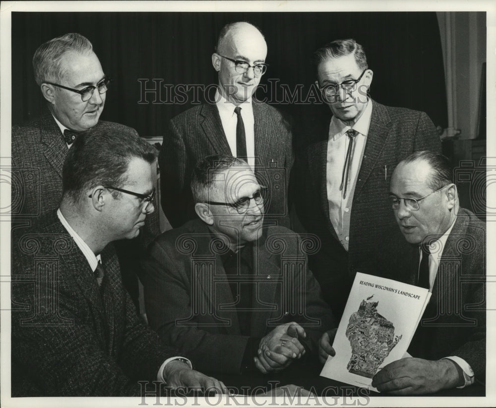 Press Photo Representatives inspecting copy of new published booklet, Wisconsin-Historic Images