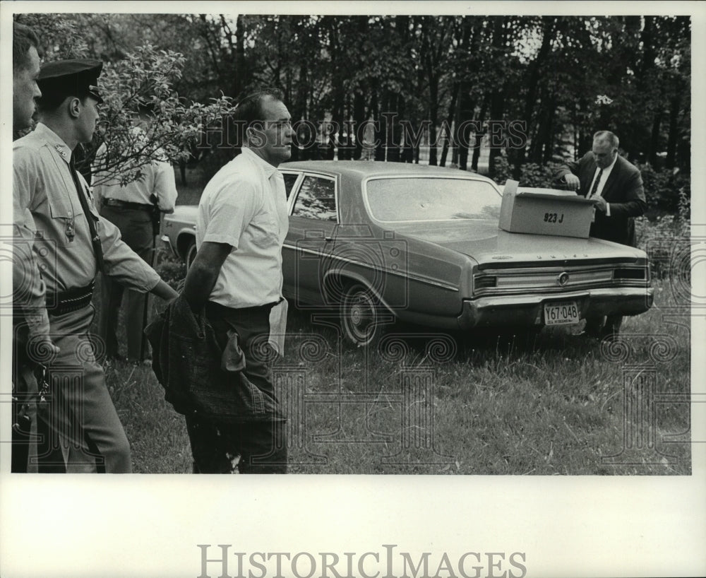 1968, Brookfield police holding a robbery suspect, Wisconsin - Historic Images