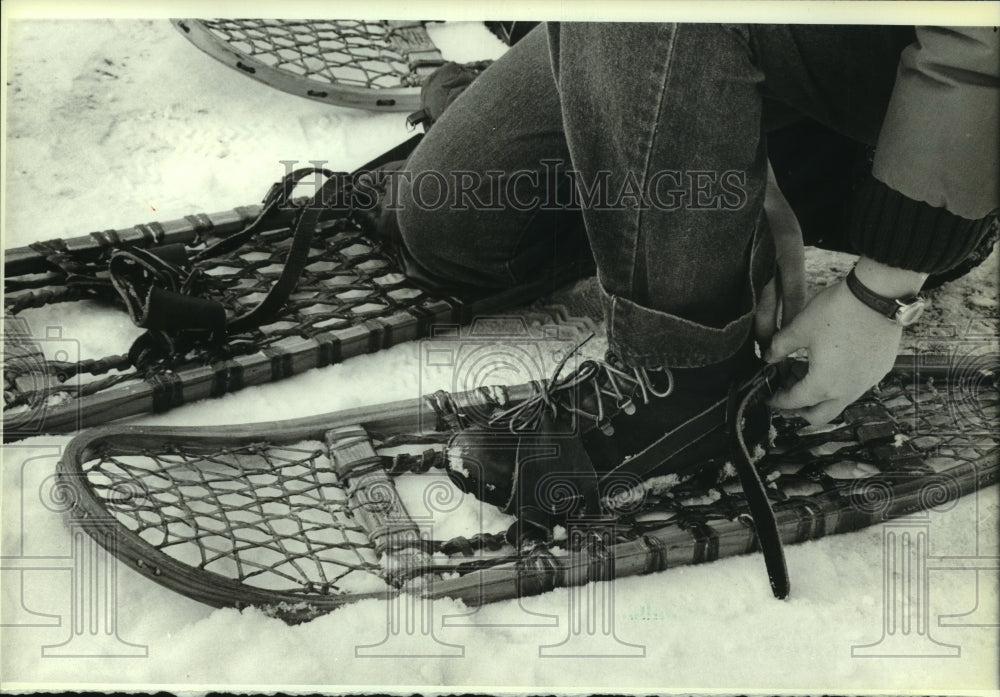 1983, Person putting on snowshoe, Muskego Park - mjc13465 - Historic Images