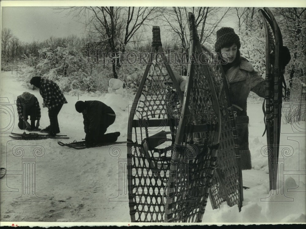 1983, Student put on snowshoes for class at Muskego Park - mjc13466 - Historic Images