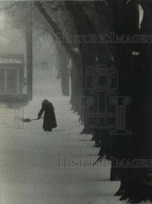 1966 Press Photo Person shoveling snow in Milwaukee, Wisconsin - mjc13863 - Historic Images