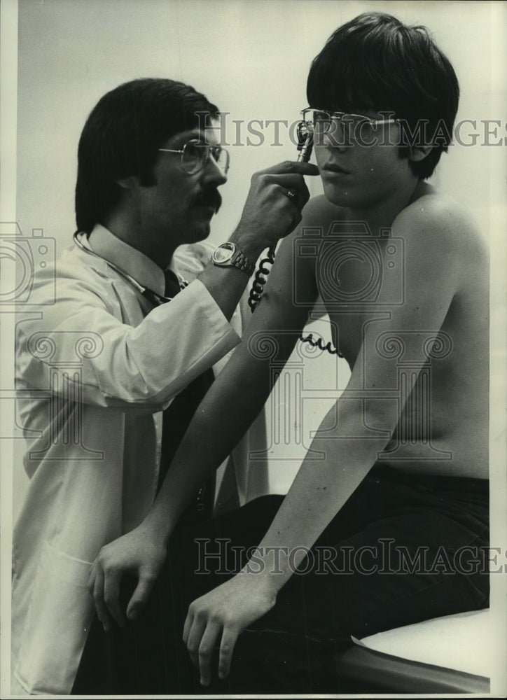 1973 Press Photo Jerry Wayne Smith examines Ted Haisher at Milwaukee Clinic-Historic Images