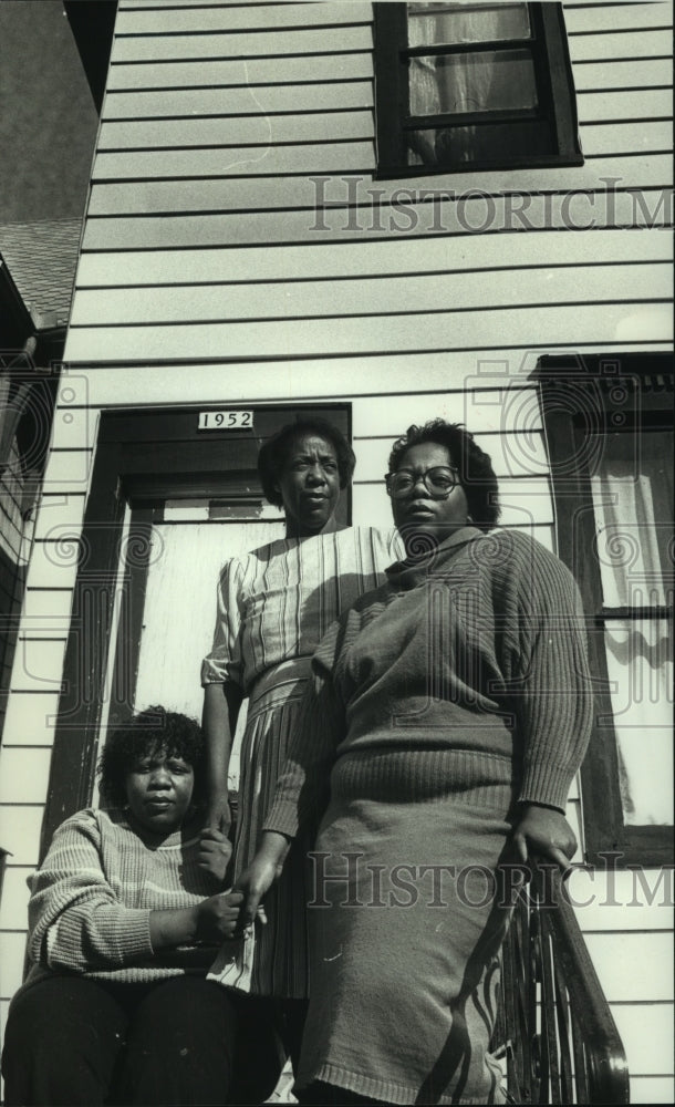 1990 Henron Smith family stood outside home on N. 26th in Milwaukee - Historic Images