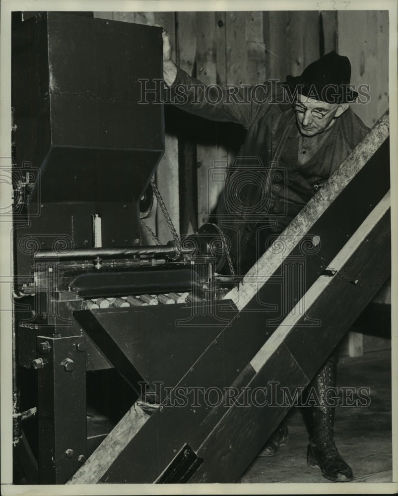 1949, Worker cuts discs of wood on industrial saw - mjc14084 - Historic Images