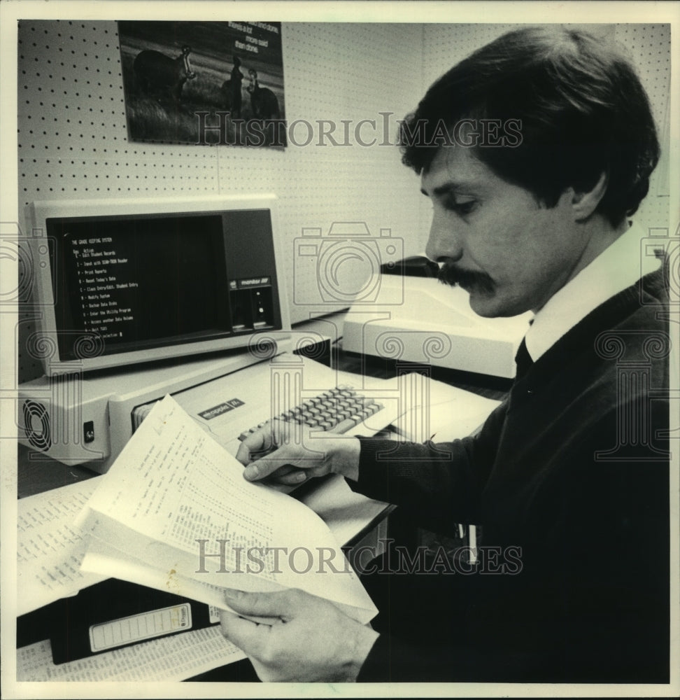 1984 Counselor Joe Weber sorts grades, Sussex, WI - Historic Images