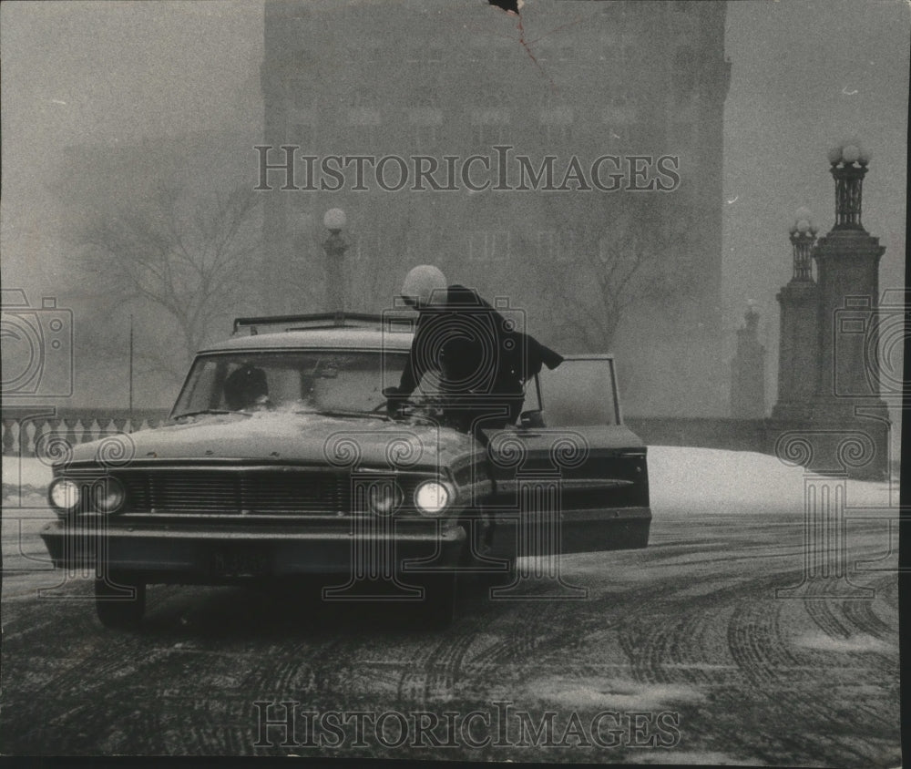 1966 Press Photo Woman Motorist Checking Windshield Wiper During Snow Storm-Historic Images