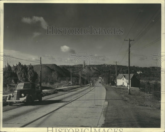 1940, Wisconsin mountains- piles of iron ore seen when drive road. - Historic Images