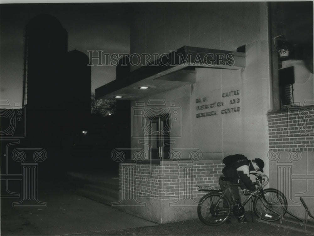 1993, Allen Flogel parks bike at U.W. - Madison Agriculture building - Historic Images