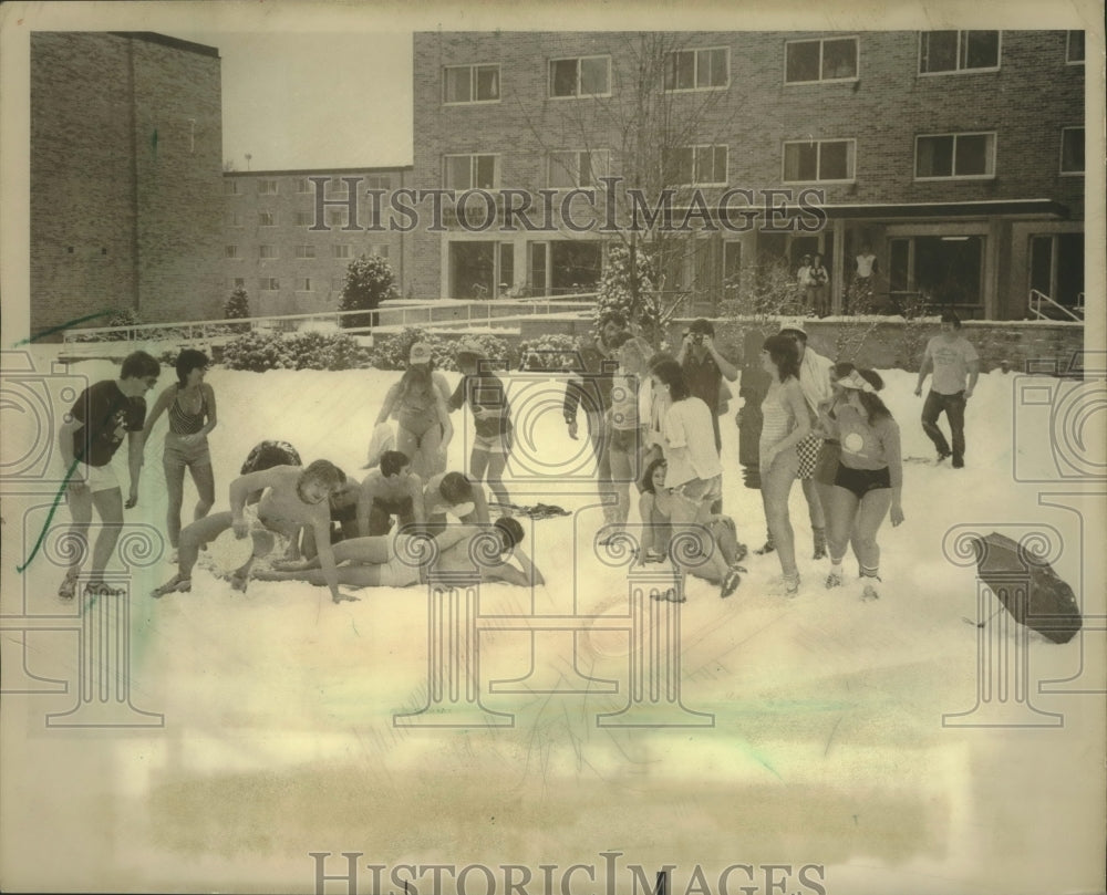1983, University of Wisconsin-Stevens Point students frolick in snow - Historic Images