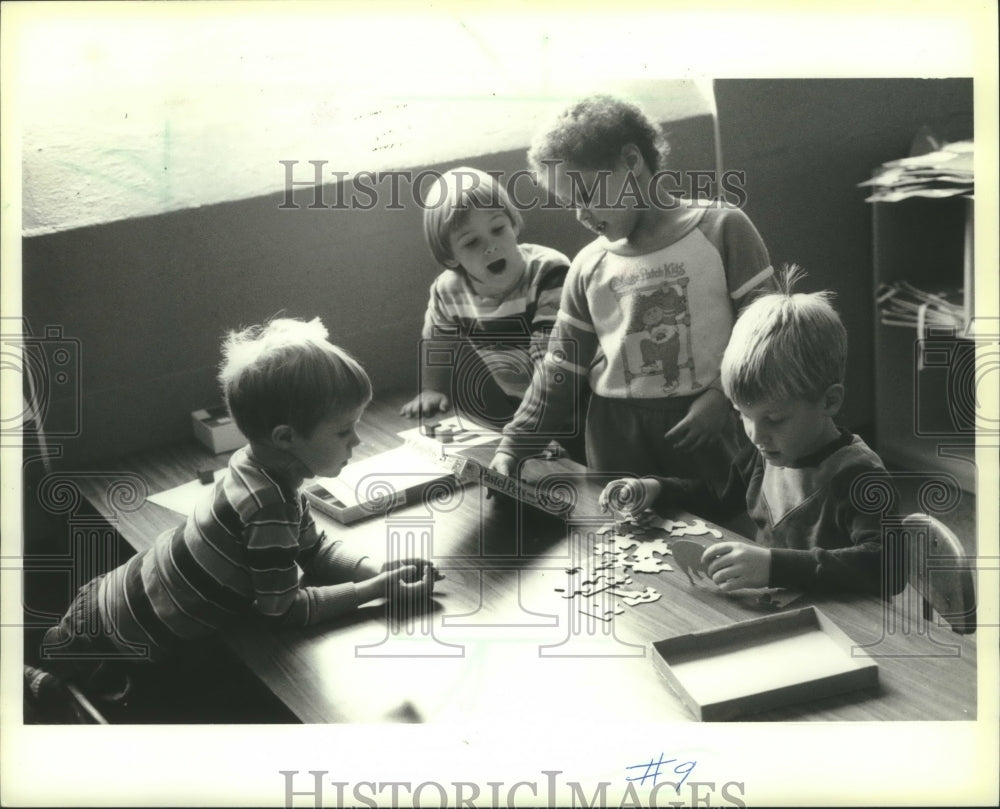 1985, Boys complete a puzzle at University of Wisconsin La Crosse - Historic Images