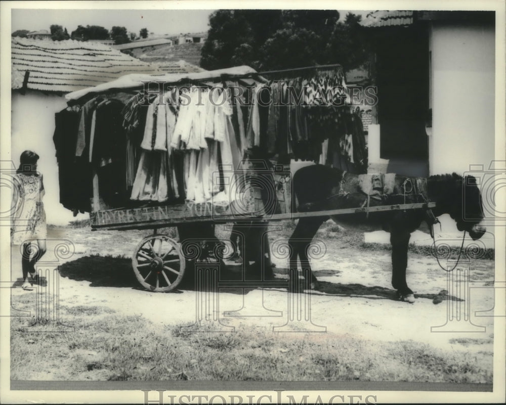 1968, Salesman sells used clothes with donkey drawn cart , Turkey. - Historic Images