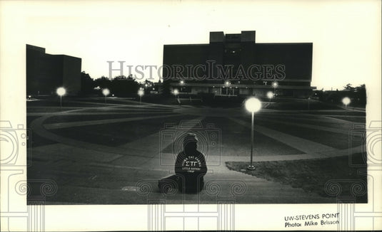1991, UW-Stevens Point student sits at the sundial - mjc15050 - Historic Images
