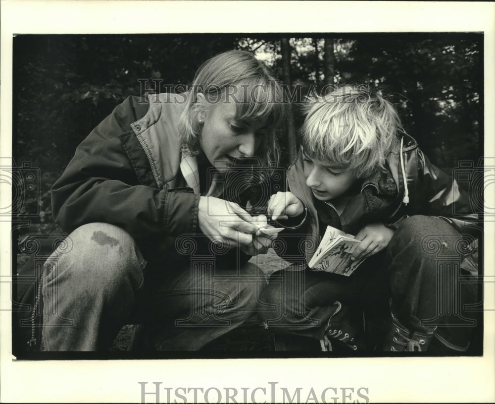1984, Mary Suritsa and student check pond specimen, UW-Stevens Point - Historic Images