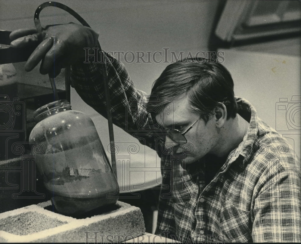 1984, Vince Tripi inspects brine shrimp, Univ. of WI--Madison - Historic Images