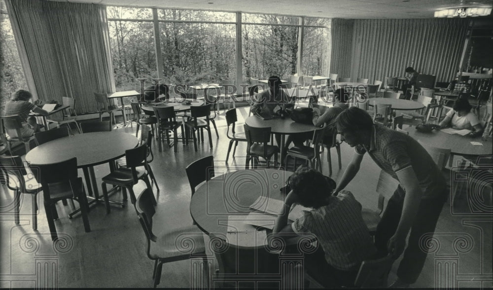 1985, University of Wisconsin students study in the cafeteria - Historic Images