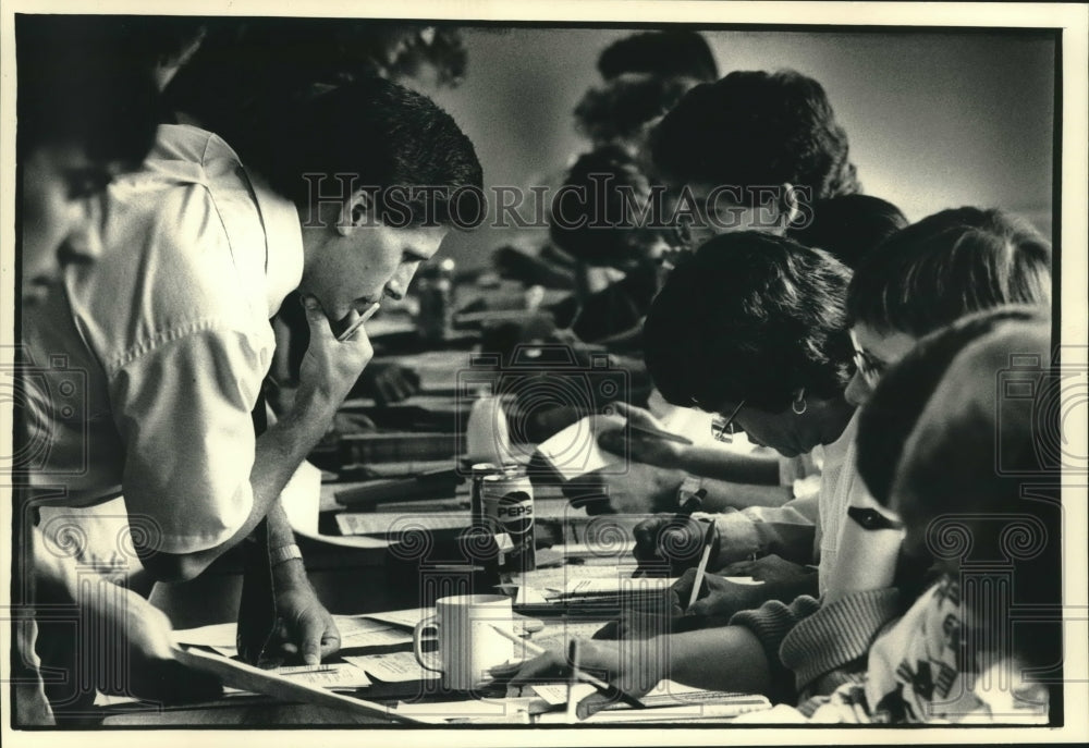 1987, UW-Milwaukee student John Levene ponders his registration form - Historic Images
