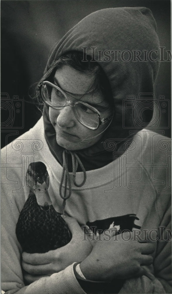 1992, UW-Stevens Point senior Andrea Seeley holds a mallard duck - Historic Images