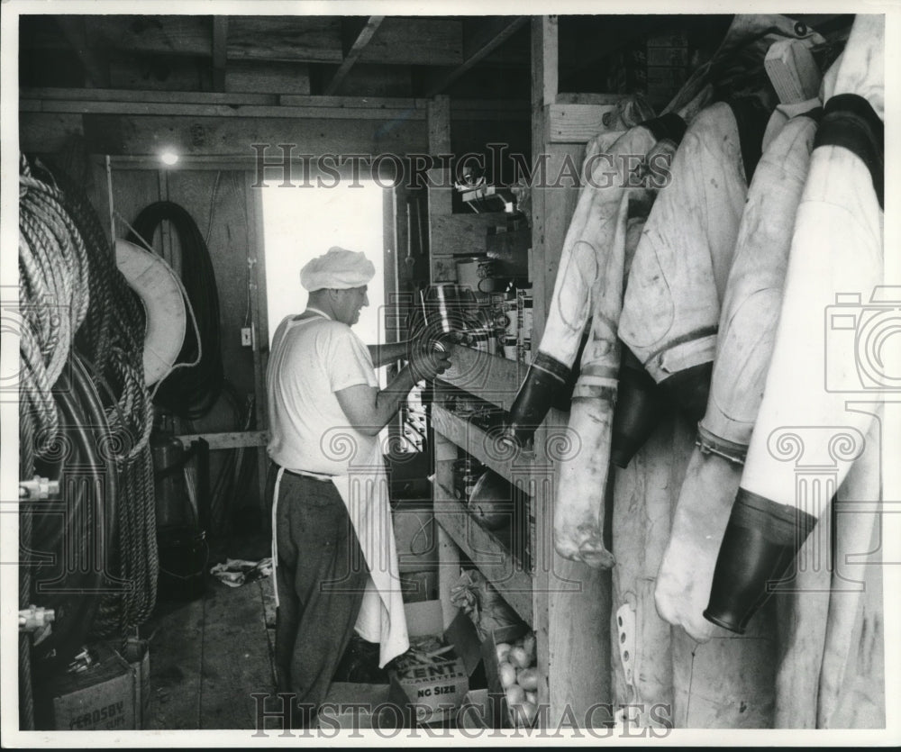 1952 Press Photo Cook Joseph Sanko checks supplies on barge used in ship salvage - Historic Images