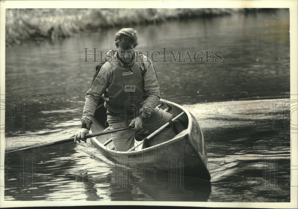 1993 Canoe paddler, Charlie Wilson, on Schlitz Audubon Center pond - Historic Images