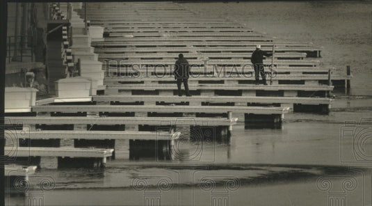 1994 Skipper Bud's Marina workers check pumps at Schlitz Park Marina - Historic Images