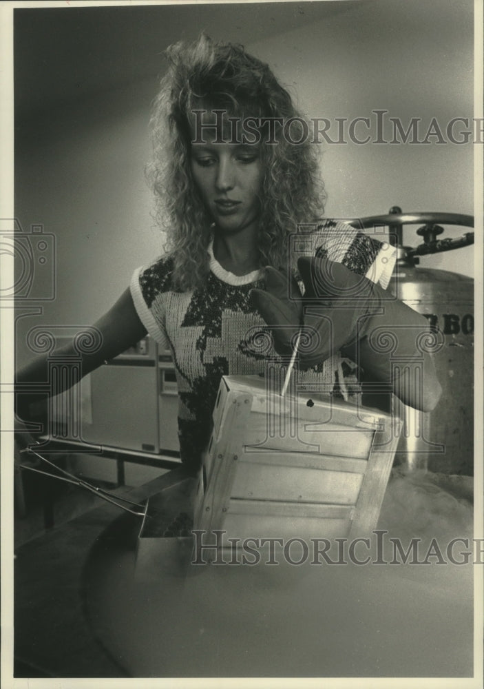 1991, Lori Rudolph lifts frozen samples at Sinai Samaritan Hospital. - Historic Images
