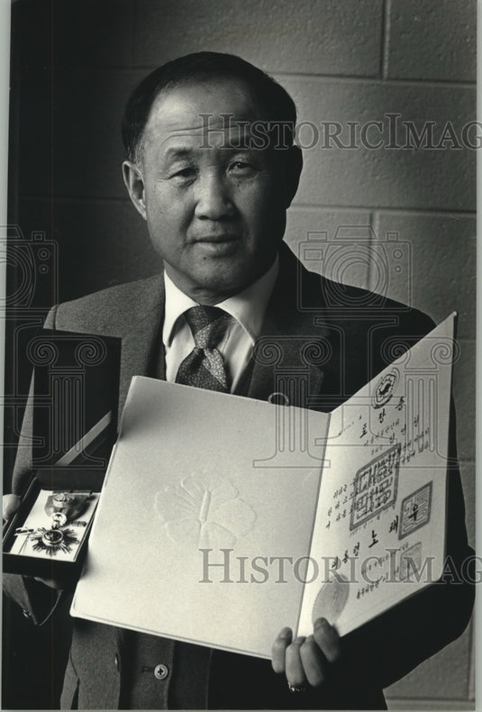 1992, Young Chul Sim holds award from South Korean government - Historic Images