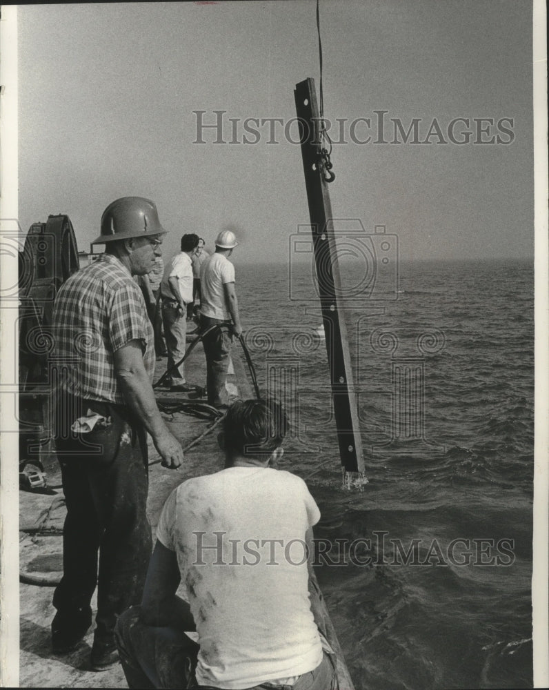 1965 Press Photo Crew members watched as a beam emerged from Lake Michigan - Historic Images