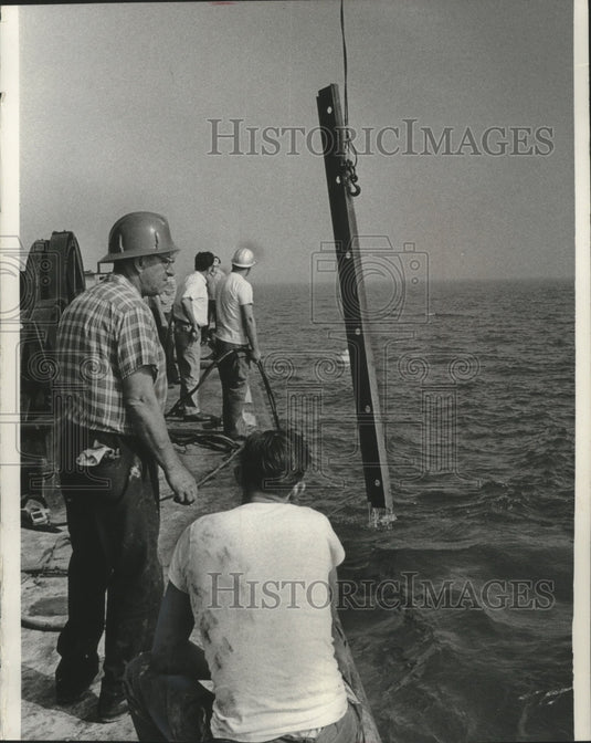 1965 Press Photo Crew members watched as a beam emerged from Lake Michigan - Historic Images