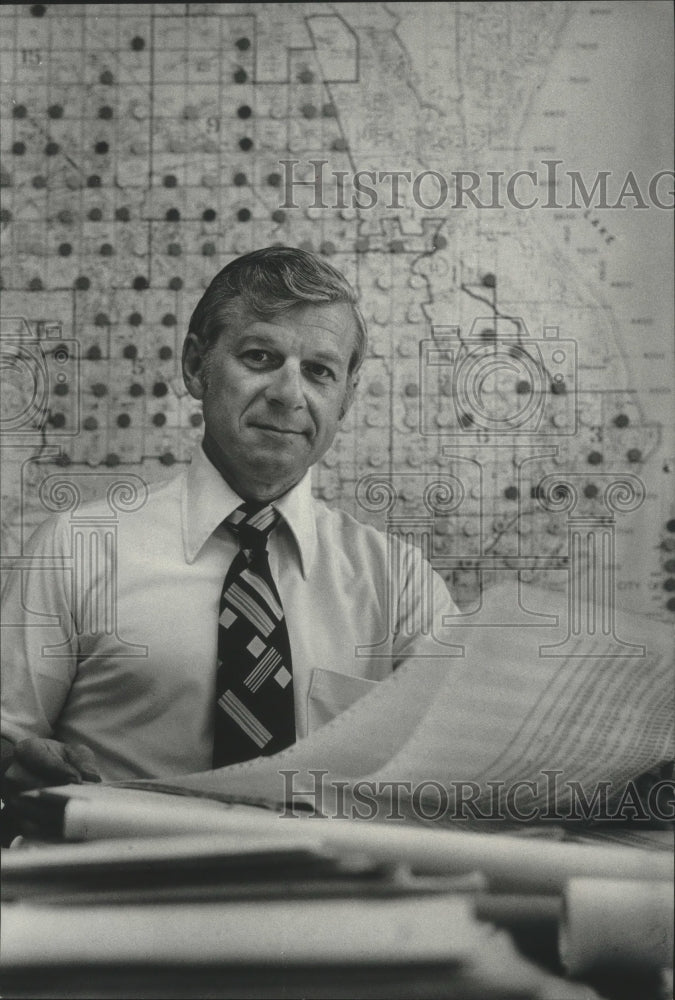 1979 Bob Skiera, Forester, sitting at desk in City Hall, Milwaukee. - Historic Images