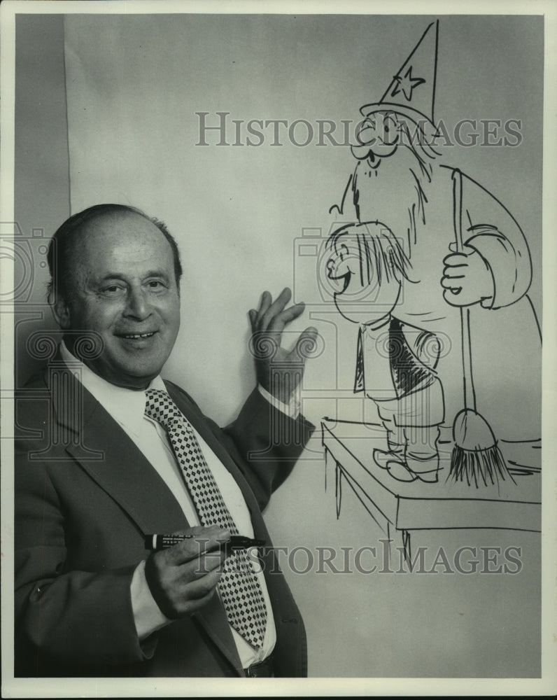 1976 Sid Stone shows off his sketch of sorcerer and child,. - Historic Images