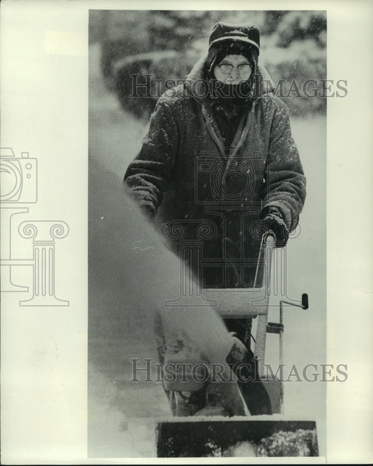 1977, Melvin McWilliams of Milwaukee WI cleans up snow after storm - Historic Images