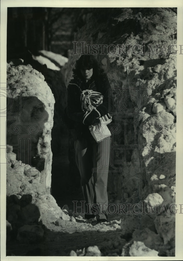 1979, Martha Apalsch walks through high banks of snow in Milwaukee - Historic Images