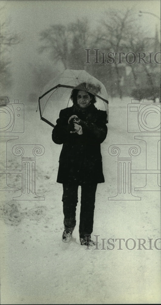 1983 Lori Ausman walks in blowing snow at University of Wisconsin - Historic Images