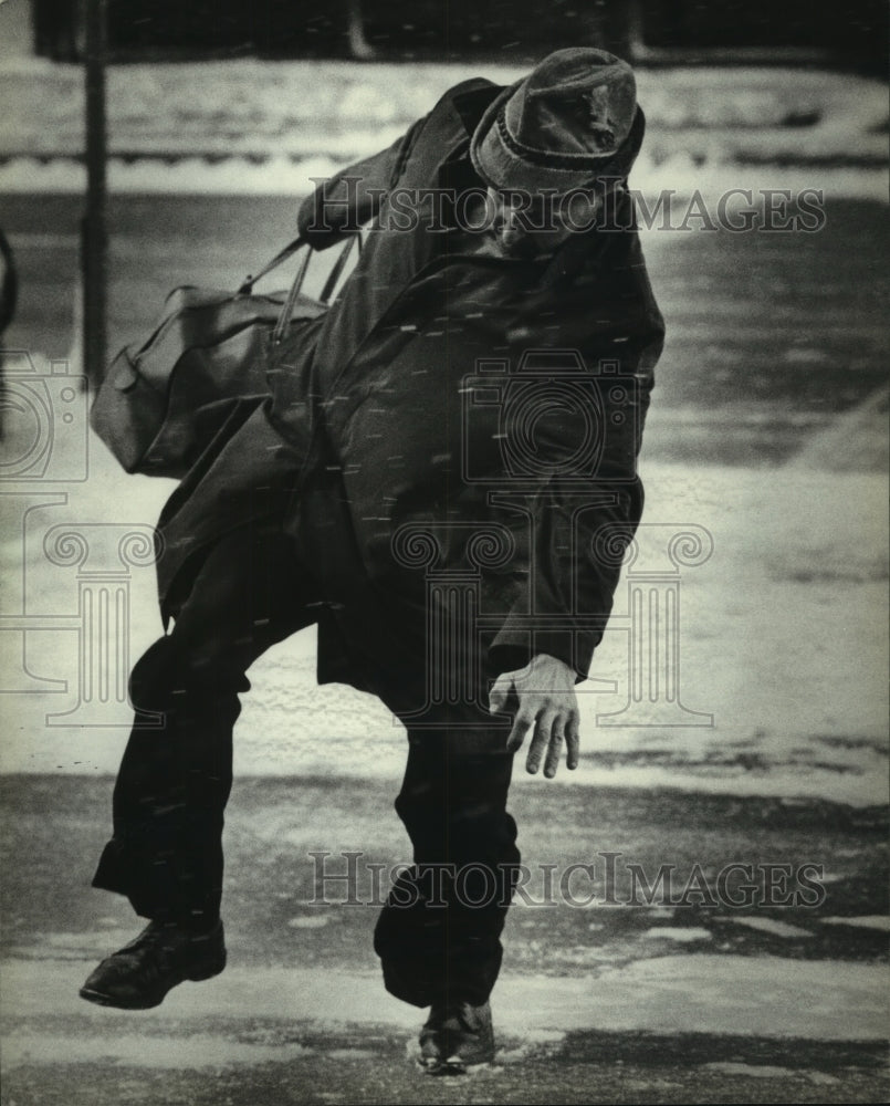 1983, A Milwaukee man struggled to keep his footing on icy street - Historic Images