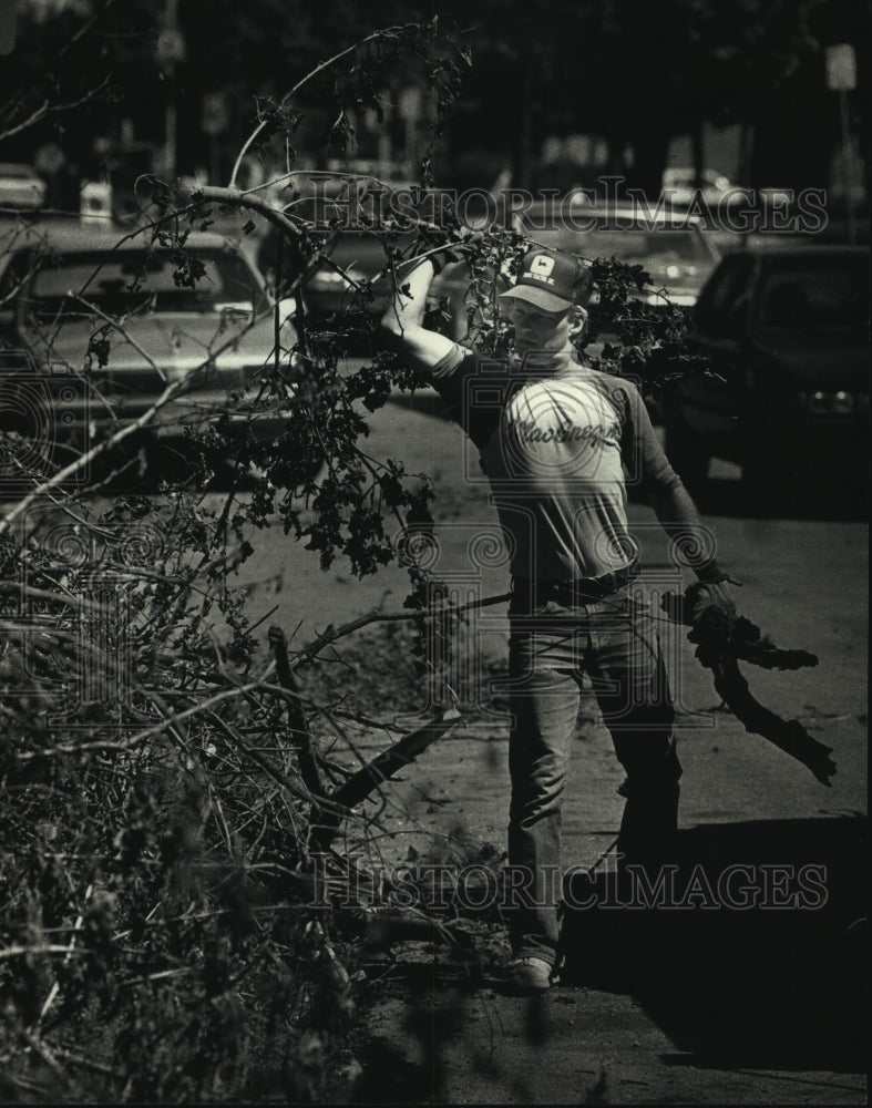 1990, Larry Price clears branches along East Avenue, Waukesha - Historic Images