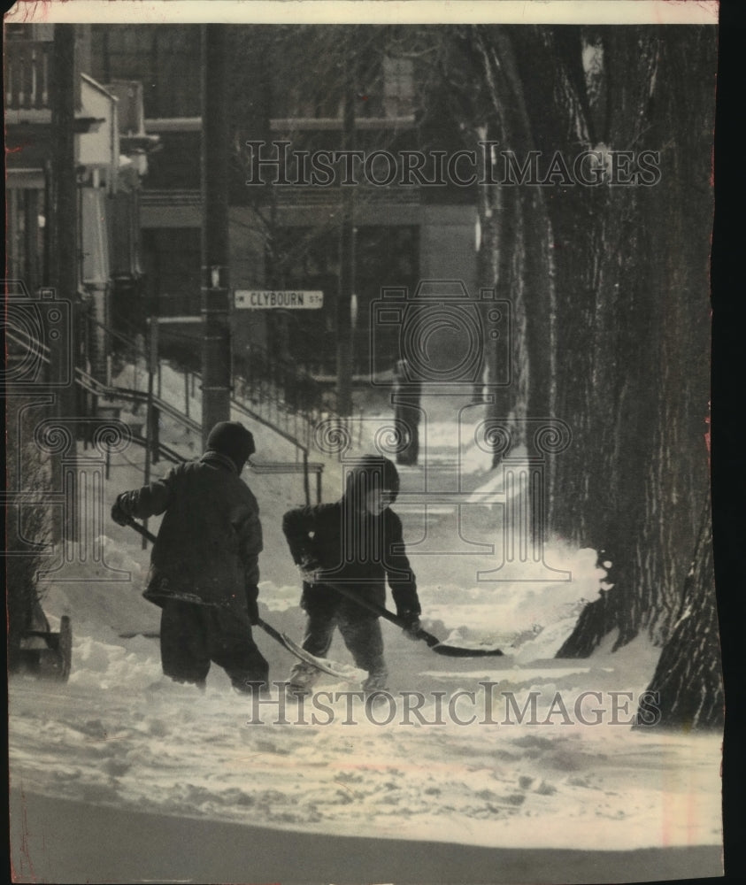 1964 Press Photo Two young boys shoveled snow to clear sidewalk in Milwaukee - Historic Images