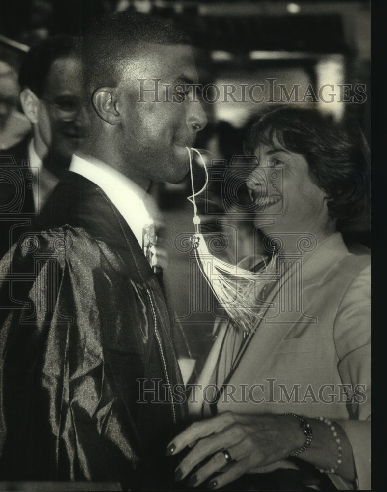 1993, student & teacher joke at graduation at University of Wisconsin - Historic Images