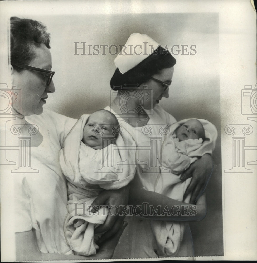 1957 Press Photo Freeman Siamese twins held by nurses after separation in Ohio - Historic Images