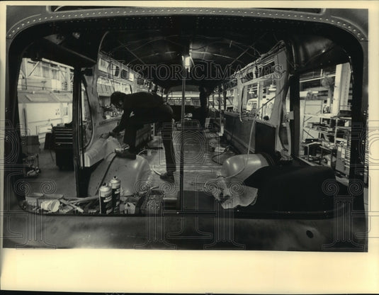 1985 Workers replaced corroded metal panels on bus being overhauled - Historic Images