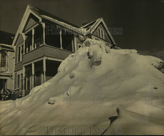 1979, Pile of snow duped on vacant lot on West Brown St., Milwaukee - Historic Images