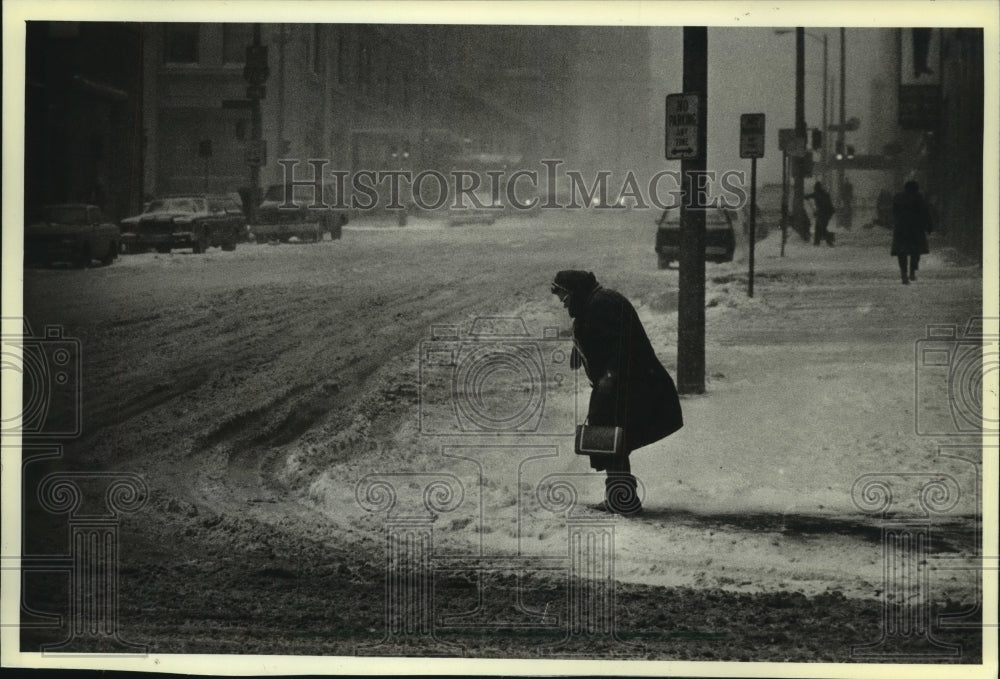 1982 A woman braced herself against wind before crossing,  Milwaukee - Historic Images