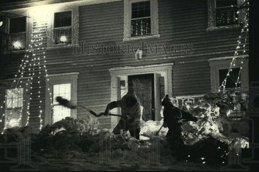 1990, Mother and son team up to clear snow from their Milwaukee home - Historic Images
