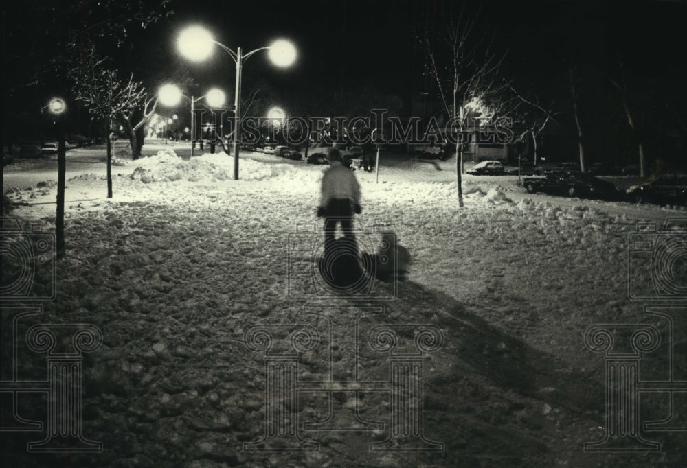 1990 Jeff Drummond pulls daughters on sleds in the snow in Milwaukee - Historic Images