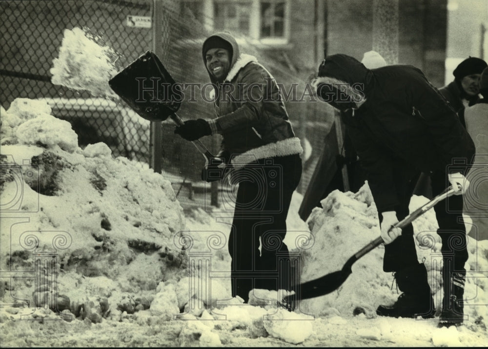 1982, Ellis McCoy, Thomas Robison clear snow from Milwaukee bus stop - Historic Images